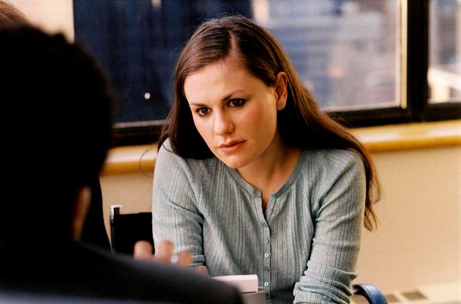 Anna Paquin in Margaret (2011). Lisa, a teenaged girl, is sitting at a table opposite a man whose back is to the camera. She leans in towards him with curiosity.